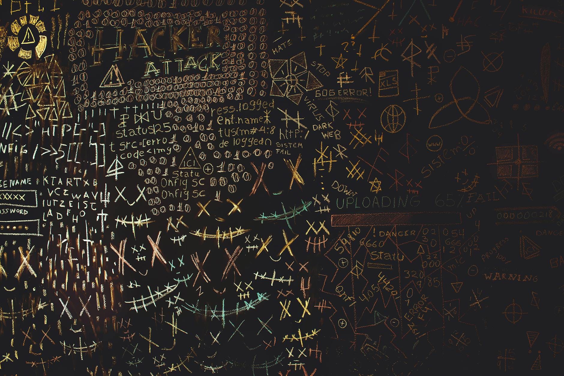 Tablica z rysunkami hakerów, kodów i geometrycznych wzorów