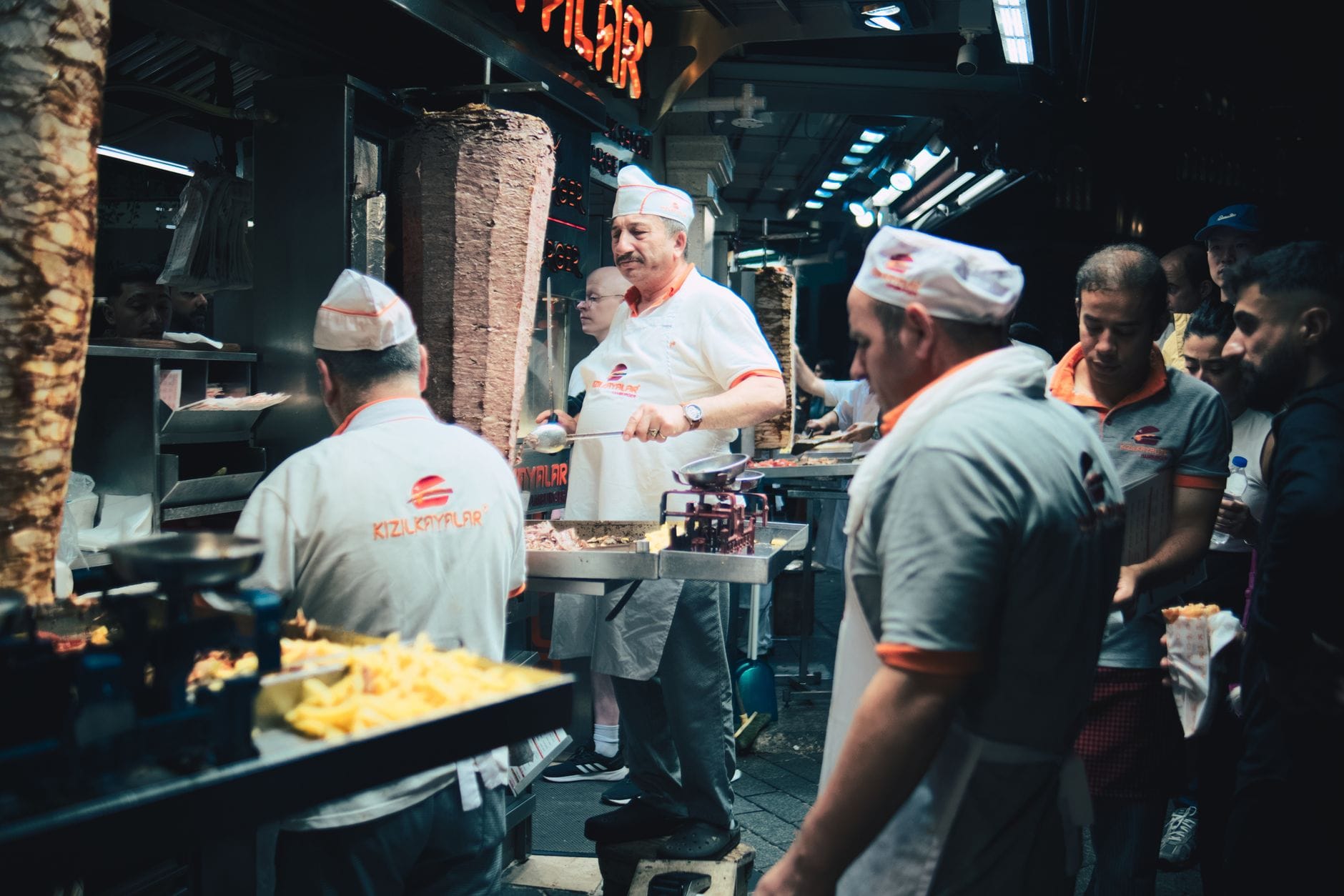 Kucharze przygotowują tradycyjny döner kebab na nocnym straganie w Stambule